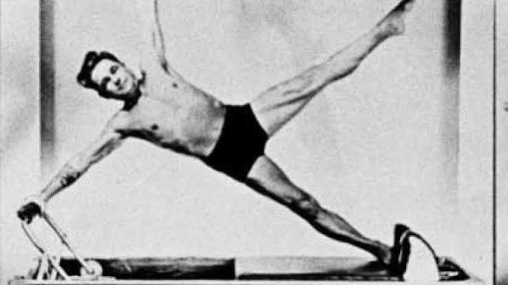 Joseph Pilates performing the star on the reformer, archival photograph